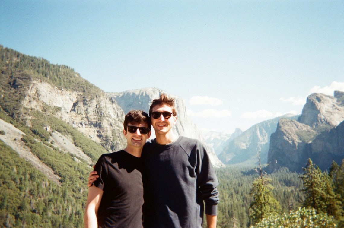 Jack and Tanner at the proposal, mountains and clouds behind them